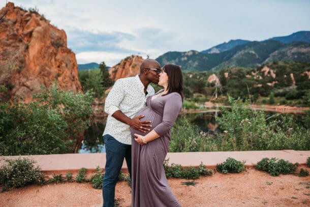 husband kisses pregnant wife